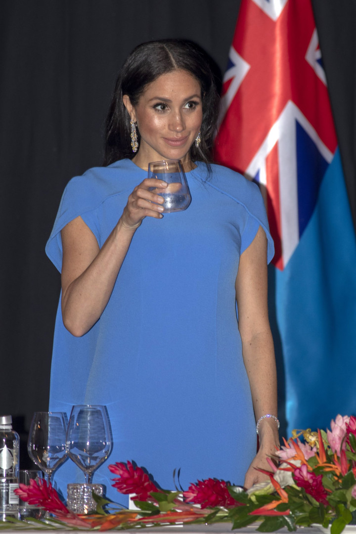 Barriguinha de Meghan Markle dá o ar de sua graça em longo vestido azul
